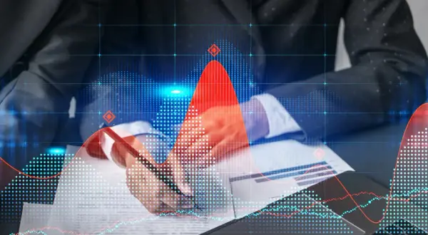 Master data specialist analizuje wykresy finansowe, pracując nad danymi.